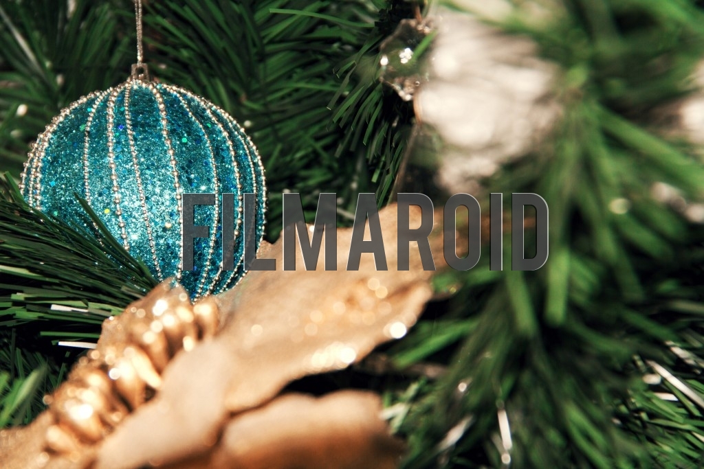 A turquoise Christmas tree ornament decorated with silver details