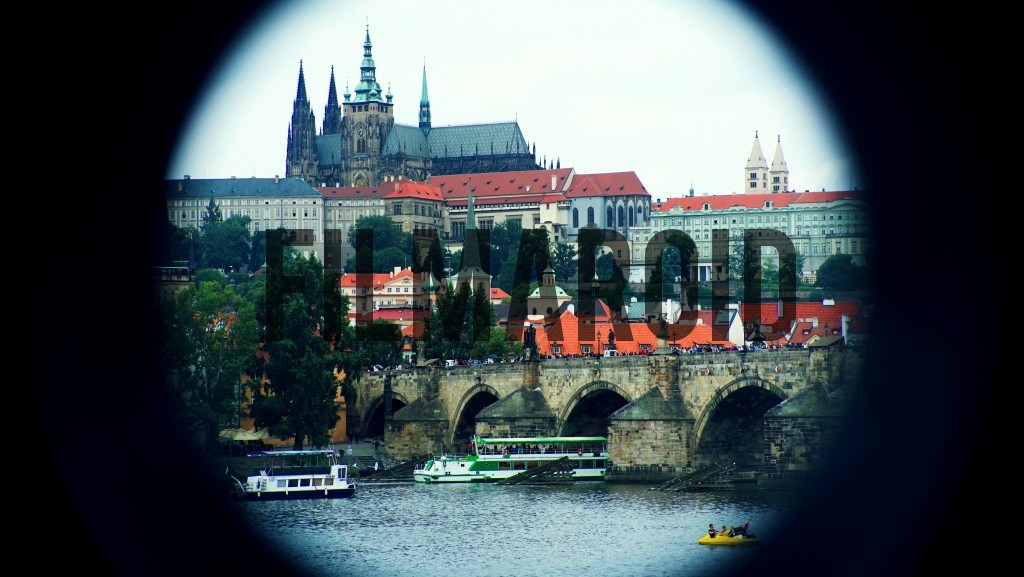 Photo taken through a keyhole of Prague Castle and Charles Bridge