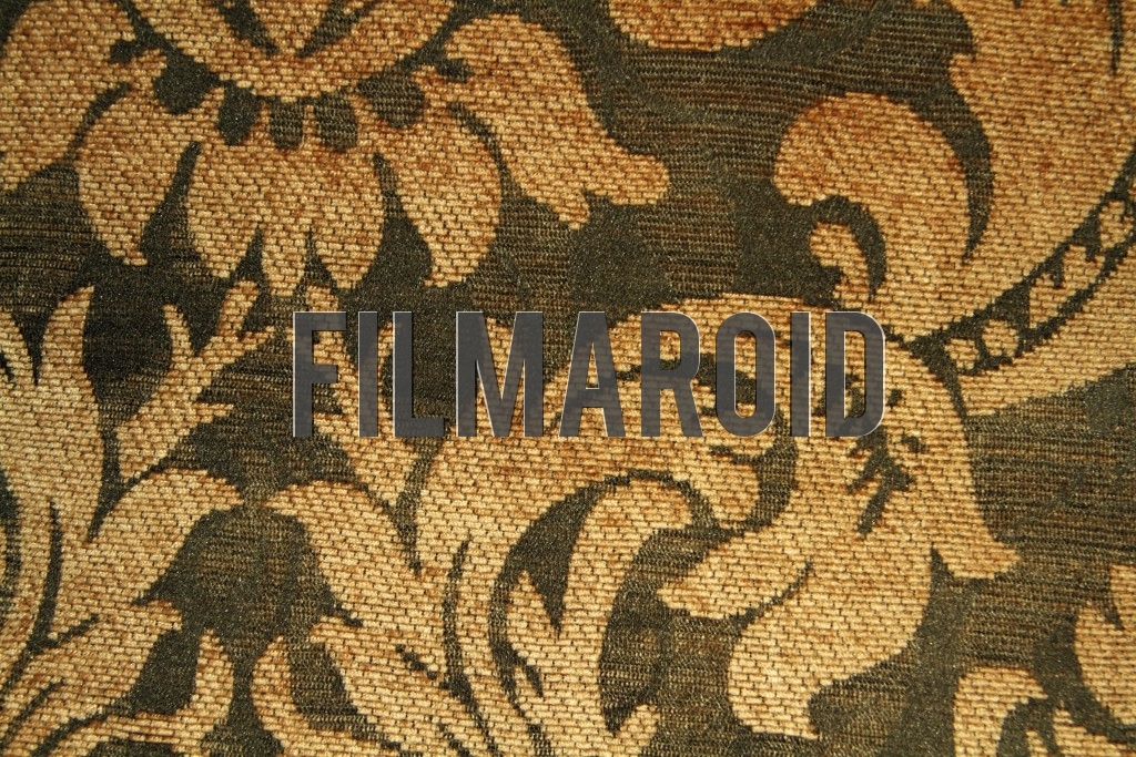 An old Victorian fabric for upholstery with golden flower patterns and green background texture