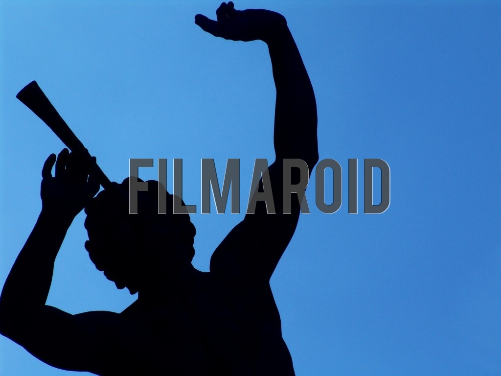 The silhouette of a Parisian statue against an intense blue background